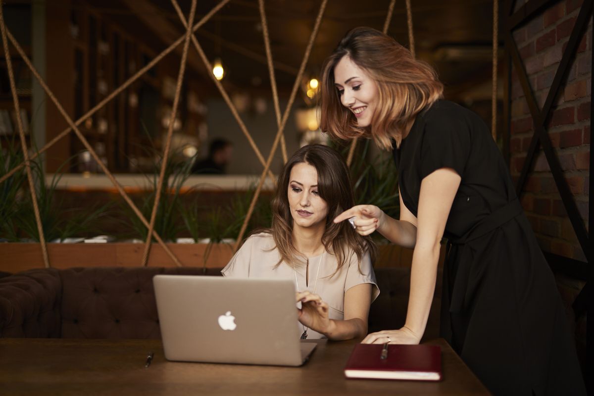 Inna working with a business owner at a laptop